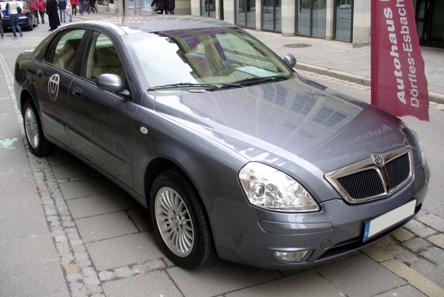 Front-side view of a silver four-door sedan with alloy wheels.