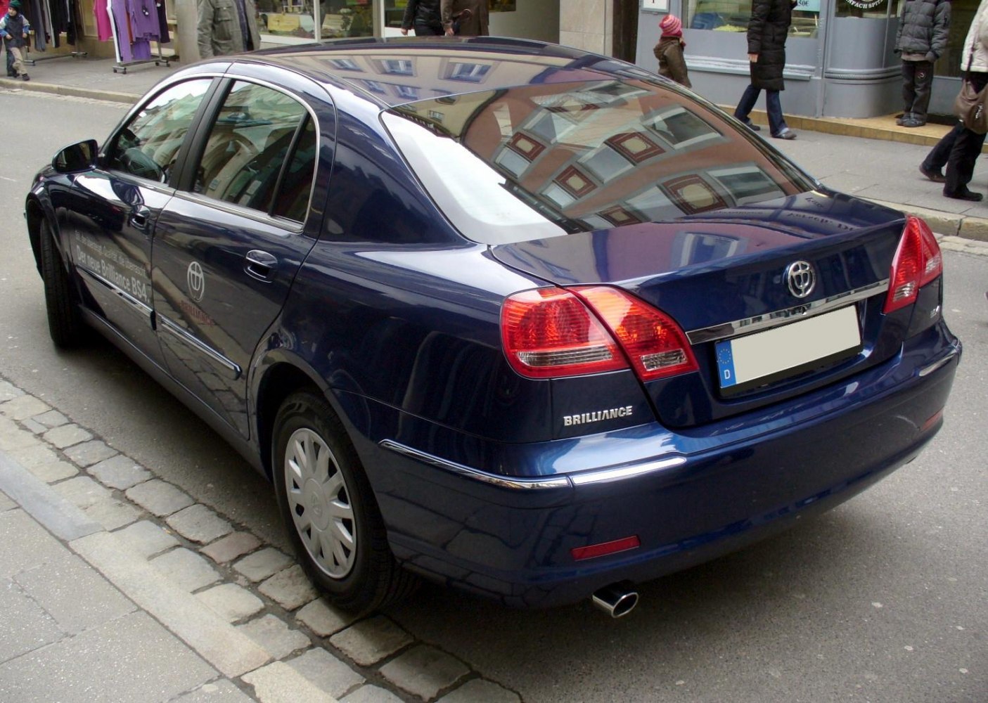 Rear view of sedan with elegant tail lights and chrome trim