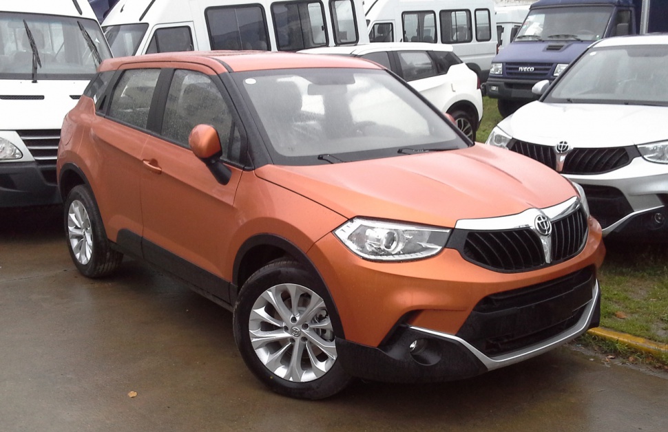Orange compact SUV with distinctive grille and alloy wheels front profile