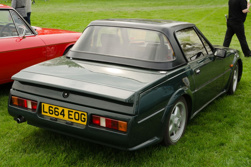 Angular tail lights and rear spoiler on a sleek hardtop coupé.