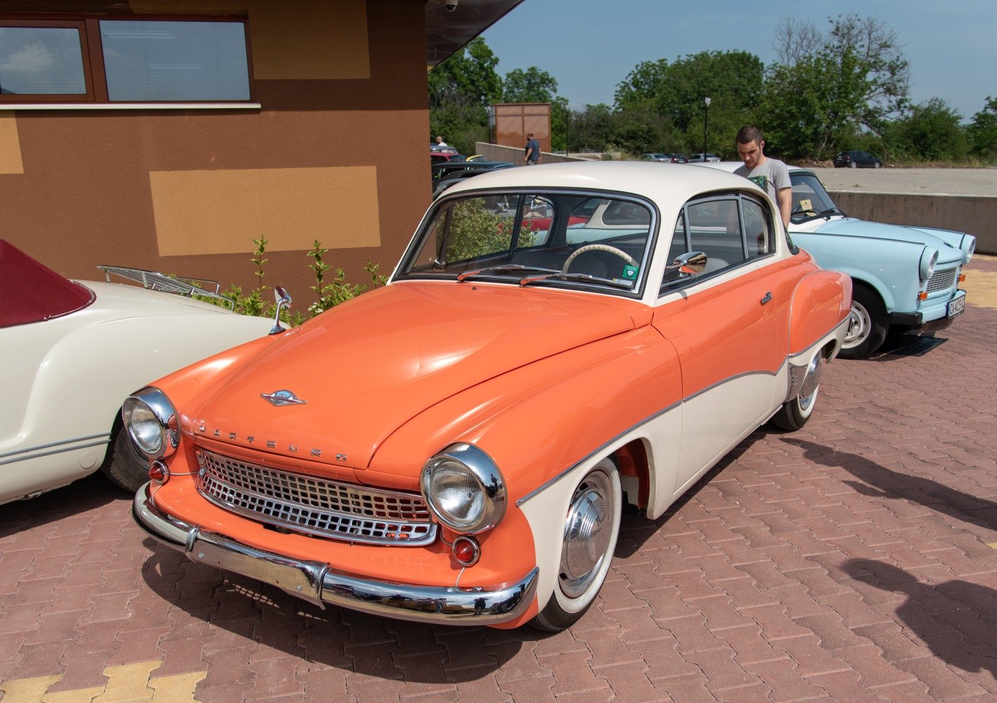 Two-tone vintage coupe with chrome grille and round headlights