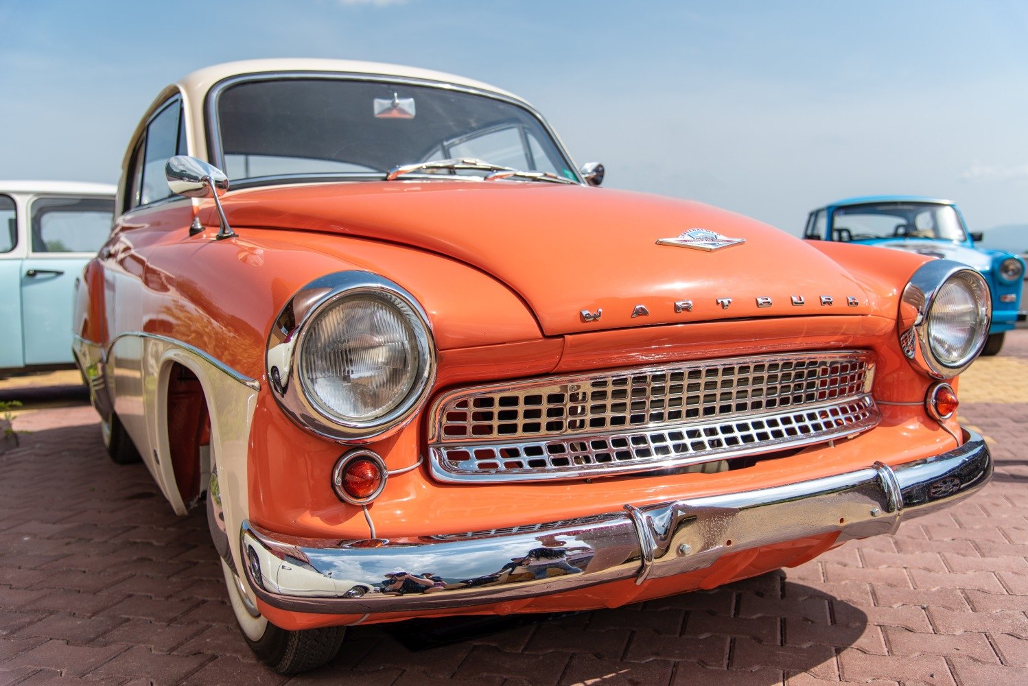Front grille with chrome details and round headlights on vintage coupe.