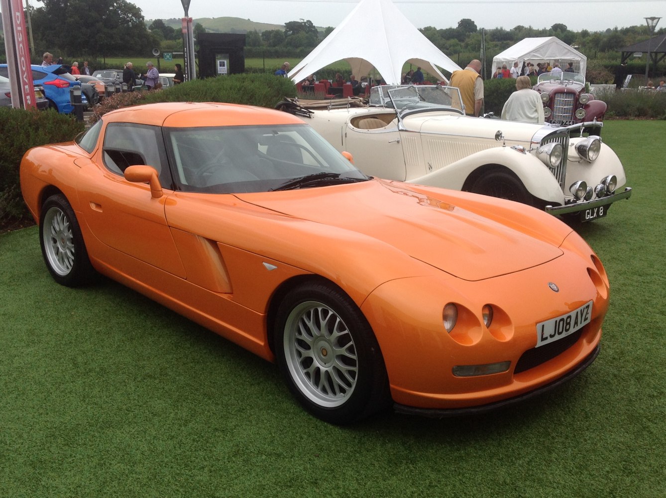 Orange sports coupe with quad headlights and sleek aerodynamic body