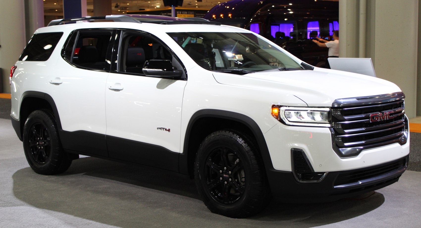 White SUV with black wheels and LED headlights front-side view