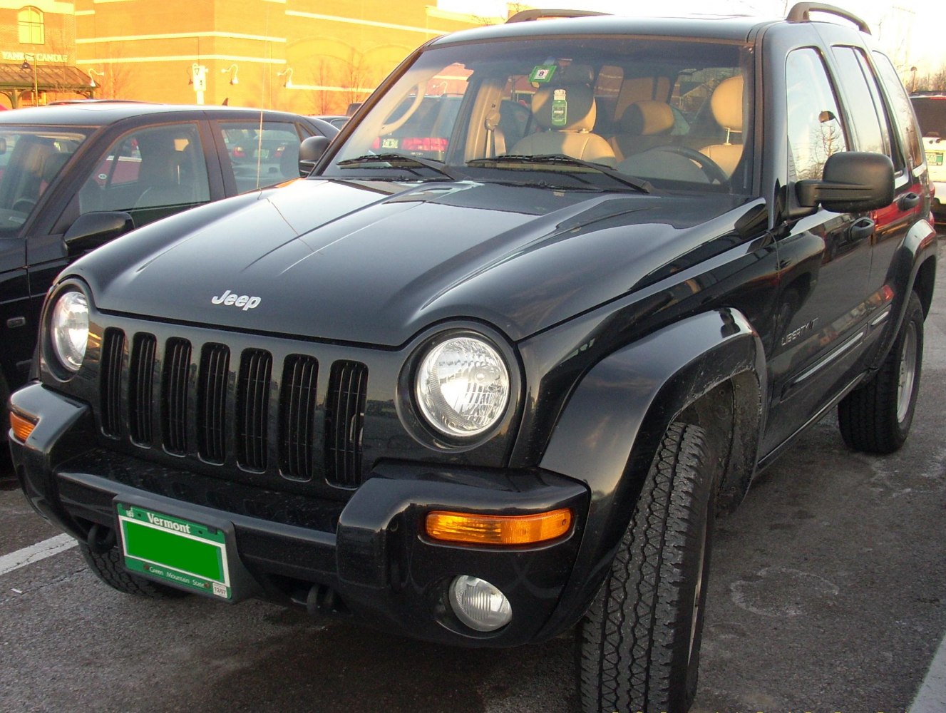 SUV front with round headlights and distinctive grille in black paint
