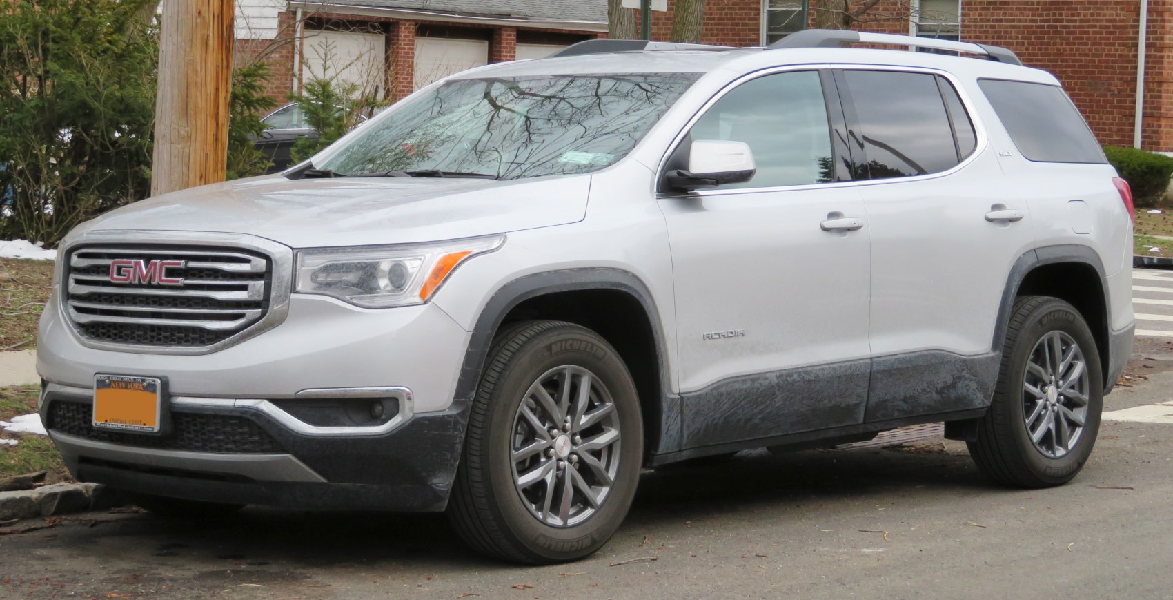 Silver mid-size SUV front-side view with bold grille and alloy wheels