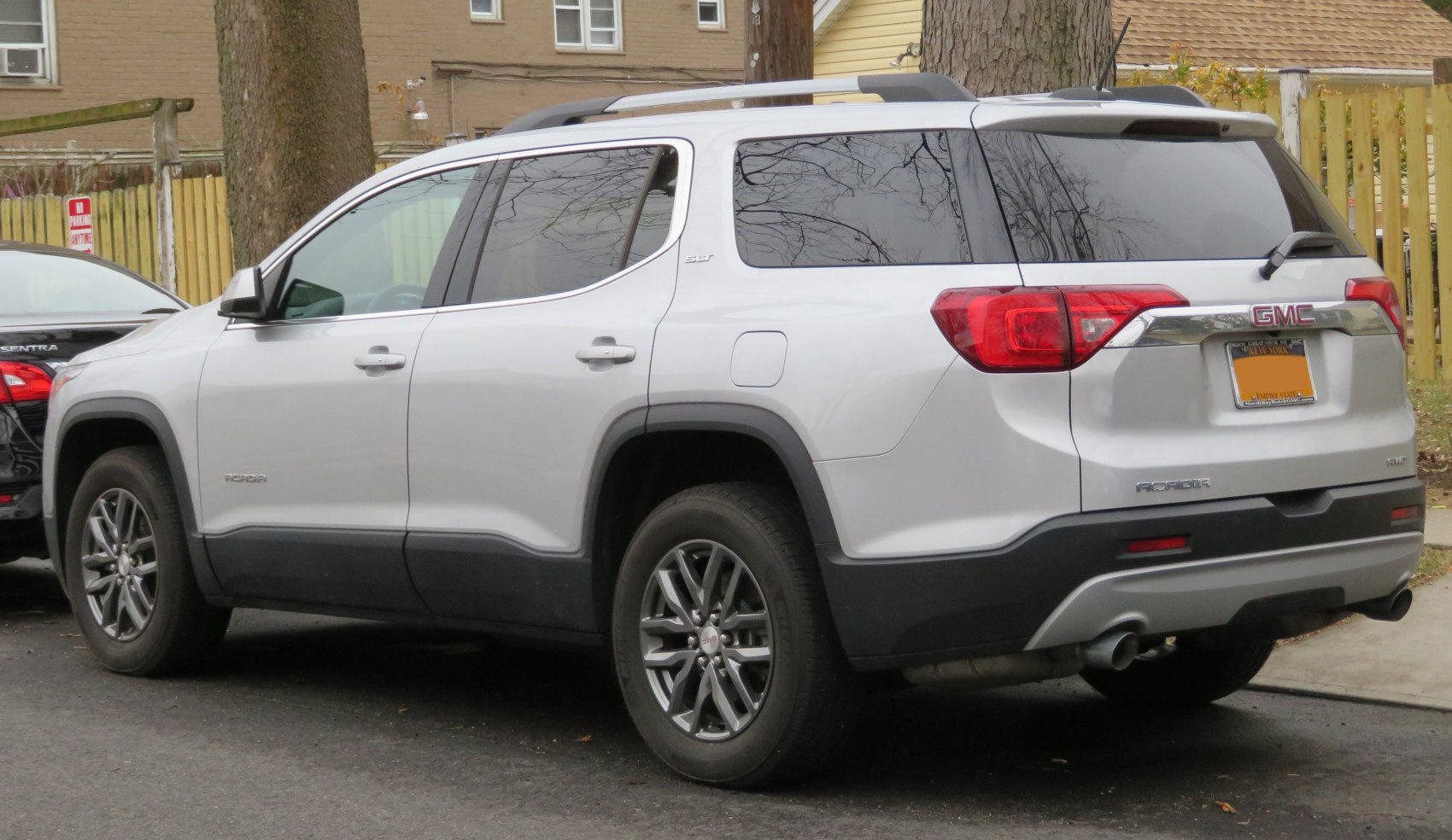 Side and rear view of mid-size SUV with roof rails and tinted windows