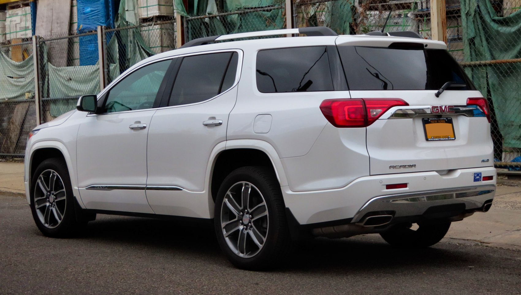 Rear side view of SUV with alloy wheels and roof rails