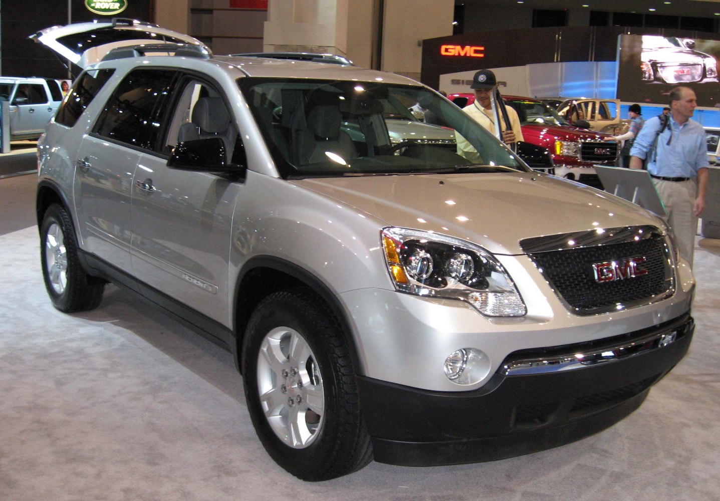 Front three-quarter view of a silver SUV with distinctive grille and headlights