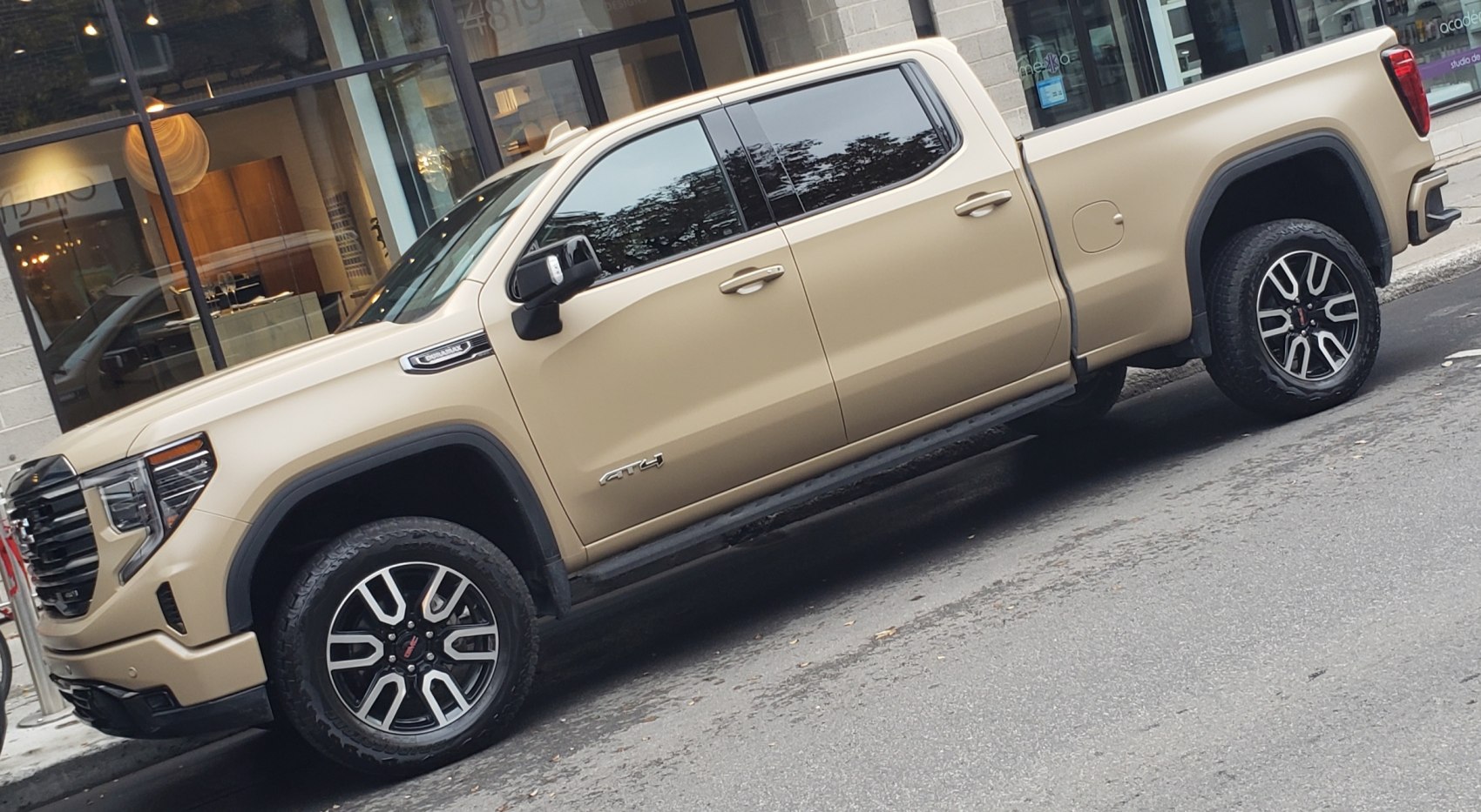 Side profile of pickup truck with off-road wheels and crew cab