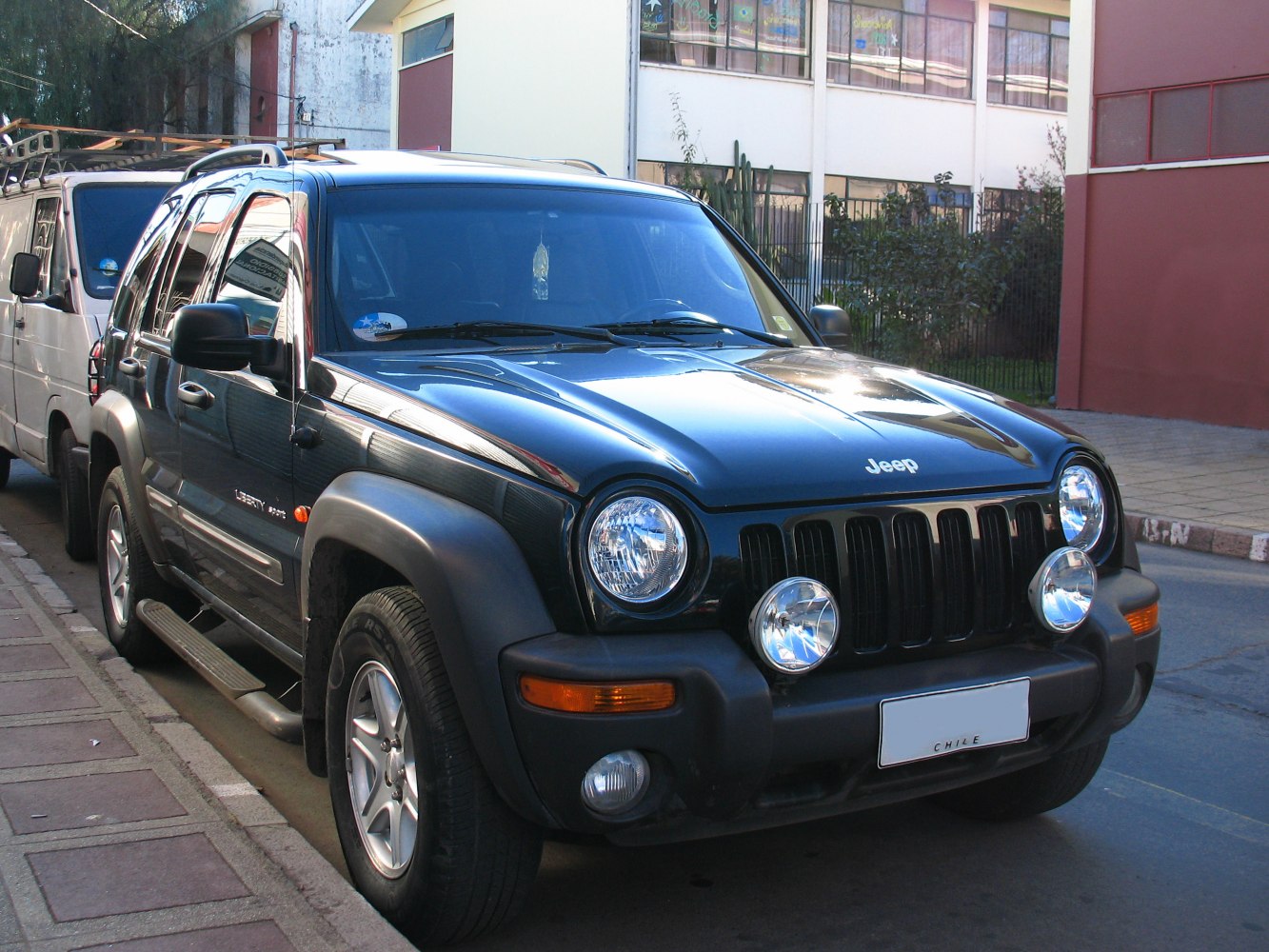 Round headlights and fog lamps on rugged SUV front.