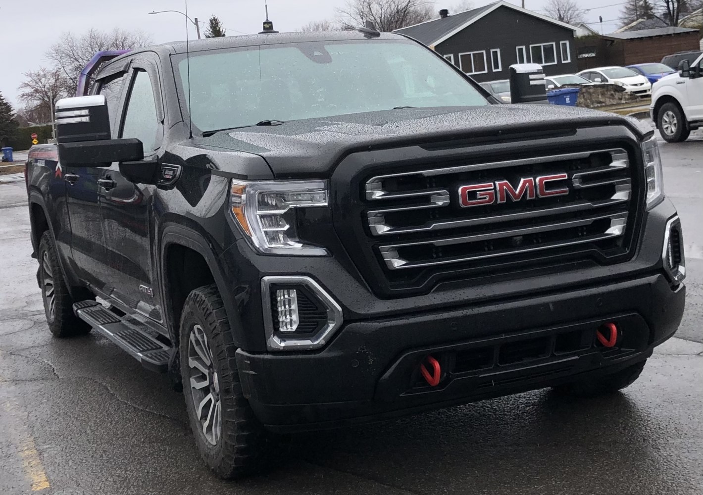 Pickup front with distinctive grille, tow hooks, large side mirrors