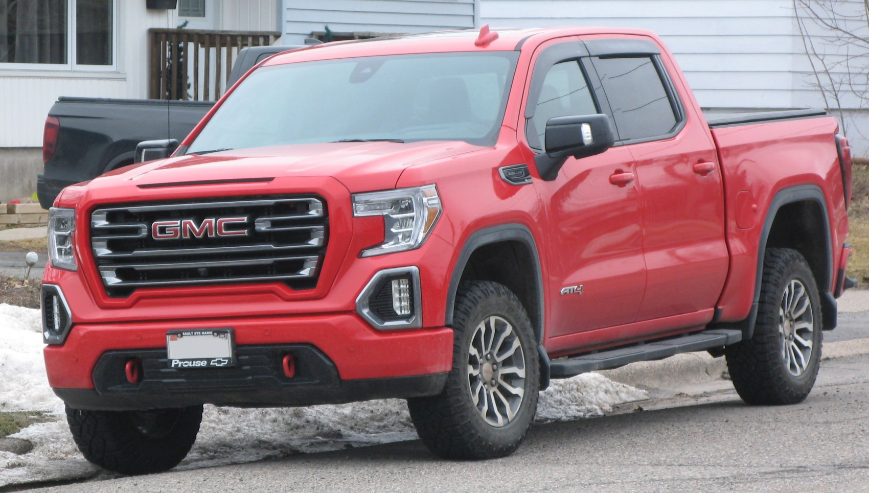 Front and side view of a pickup with distinctive grille and off-road tires