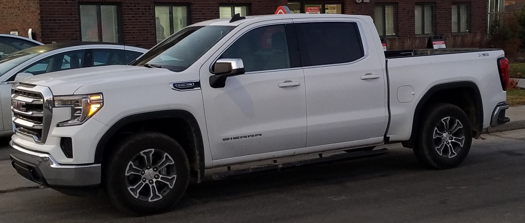Side profile of a crew cab short box pickup with rugged wheels