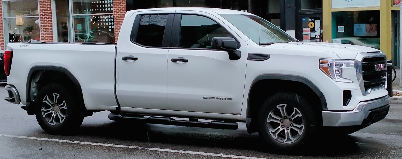 Side profile of double cab pickup with rugged wheels