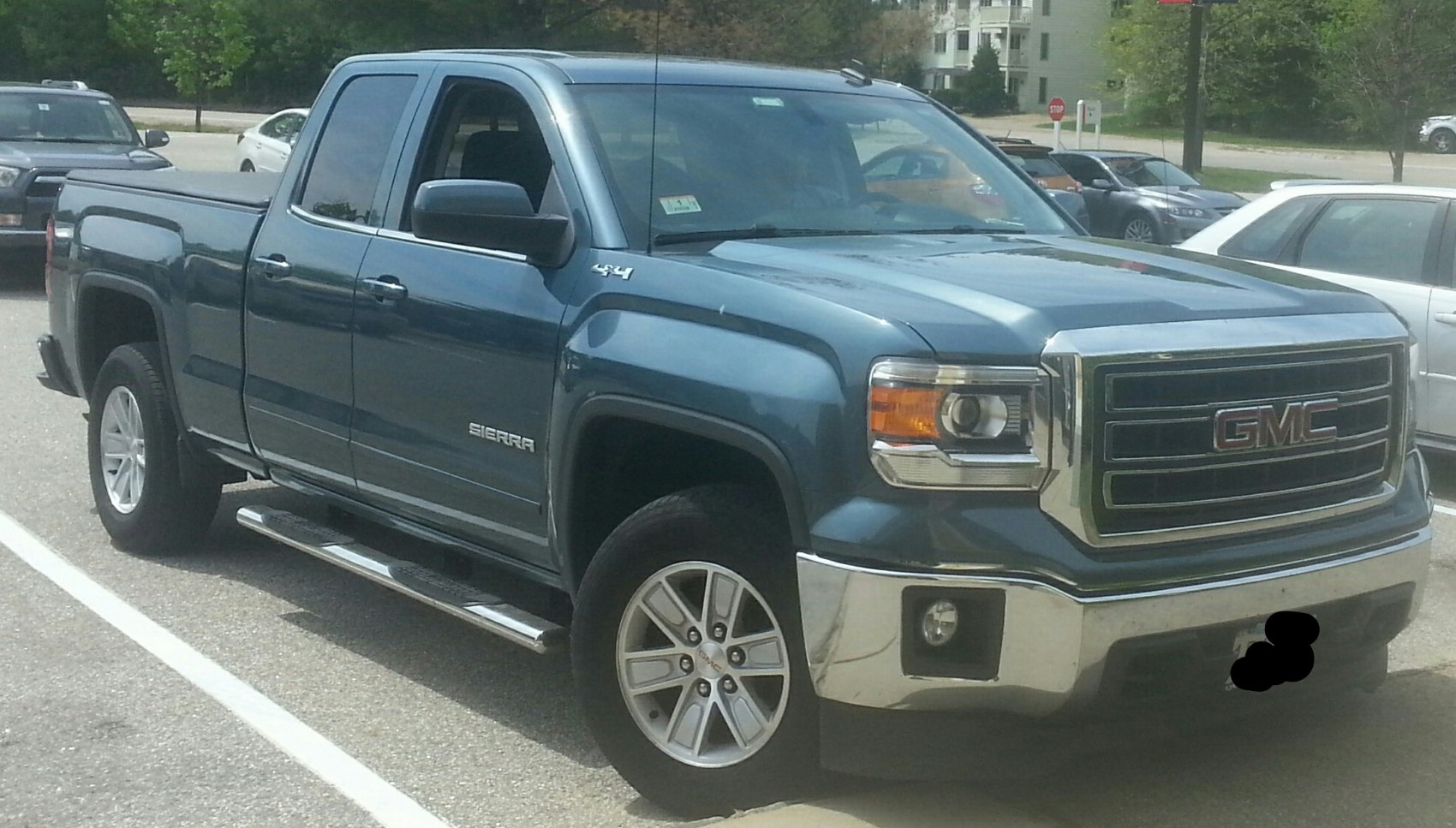 Pickup truck front-side view with chrome grille, alloy wheels, and side steps