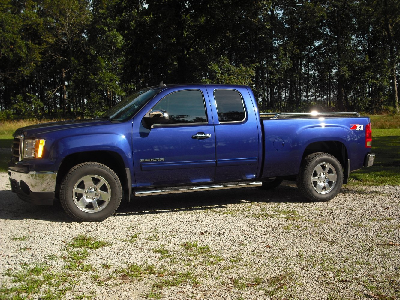 Extended cab pickup truck with standard box and chrome wheels