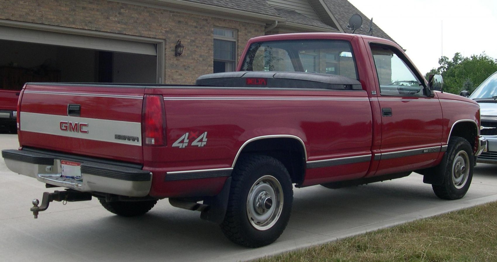 Regular cab red pickup with long wheelbase and wide bed 4x4 drivetrain