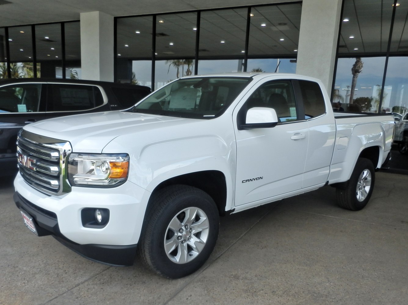 White extended cab long box pickup with chrome grille and alloy wheels