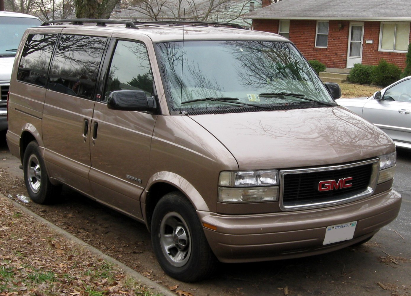 Front-side view of minivan with sliding doors and tinted windows