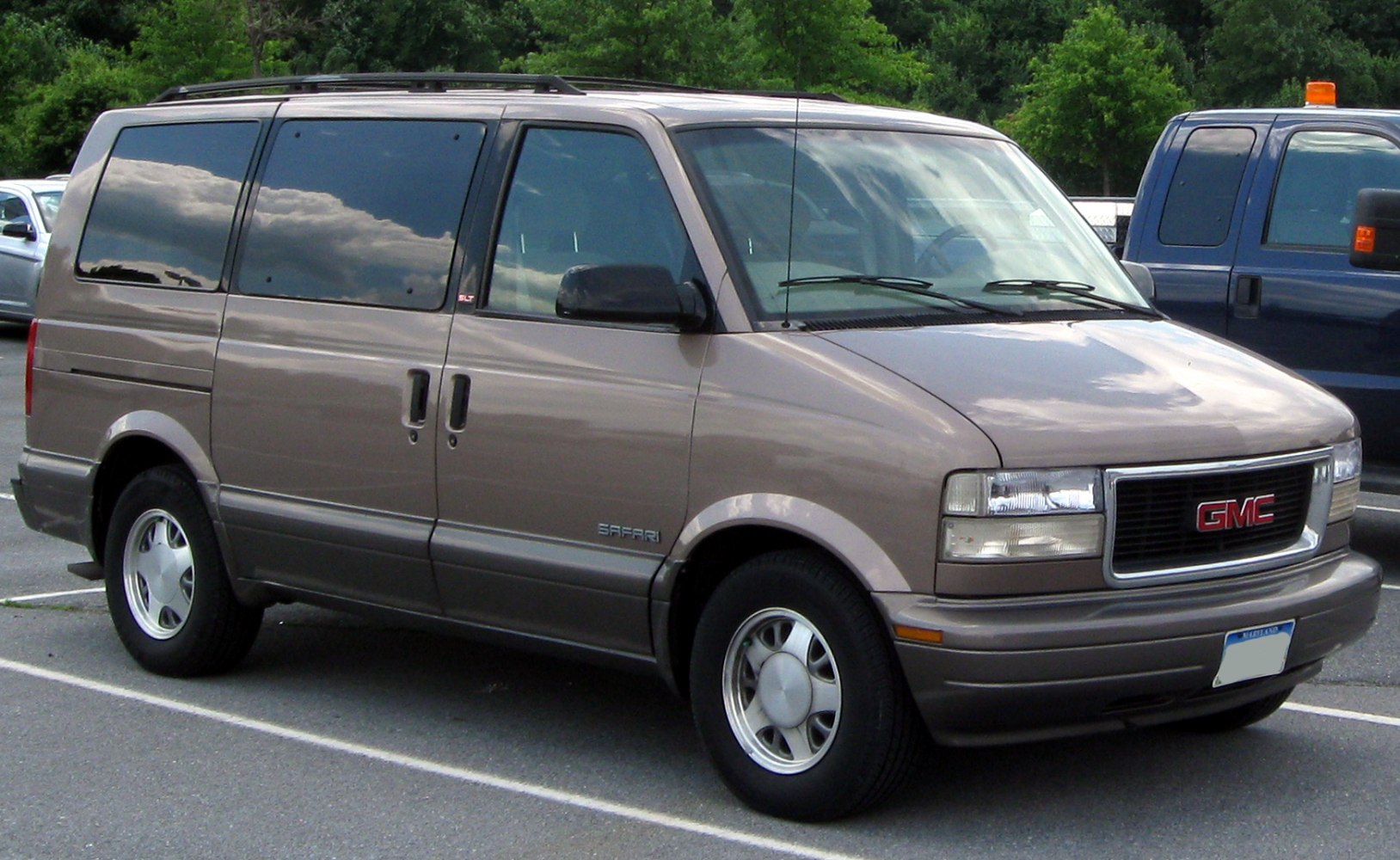 Minivan with sliding side door, tinted windows, front grille.