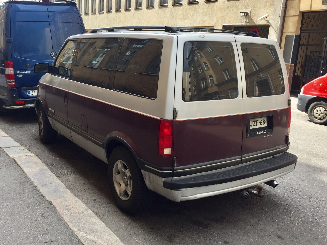 Rear view of a minivan with split rear doors and tinted windows