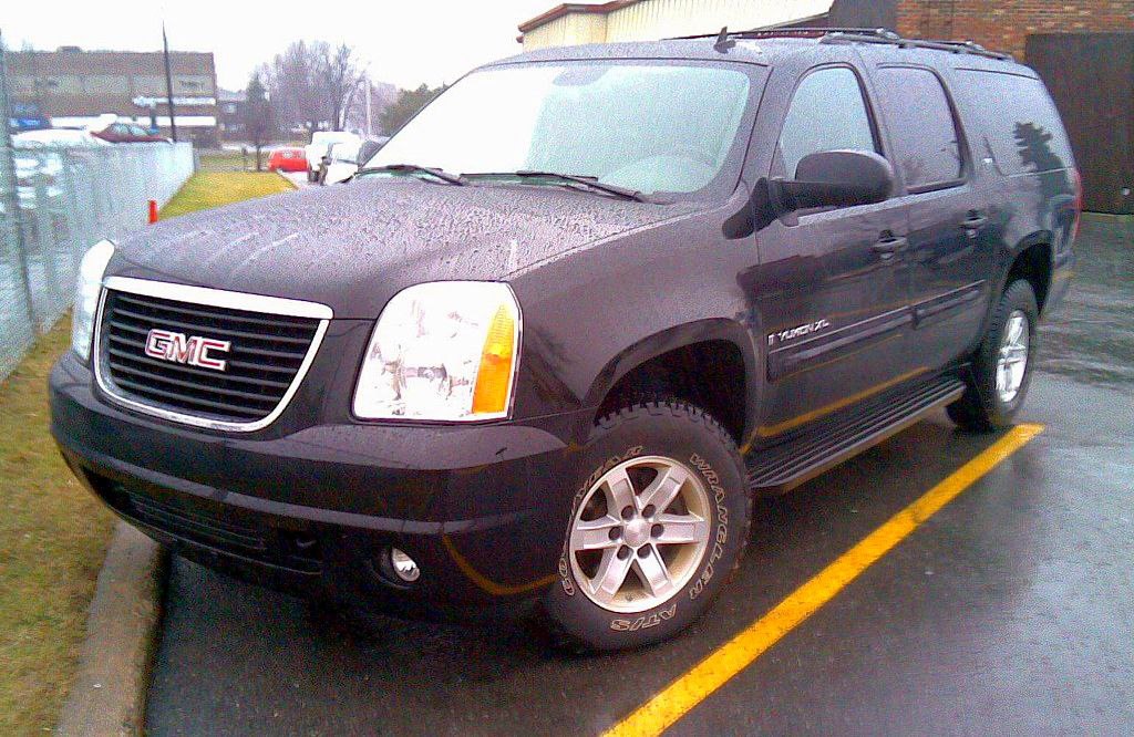 Black SUV showing front grille and side profile with rugged tires