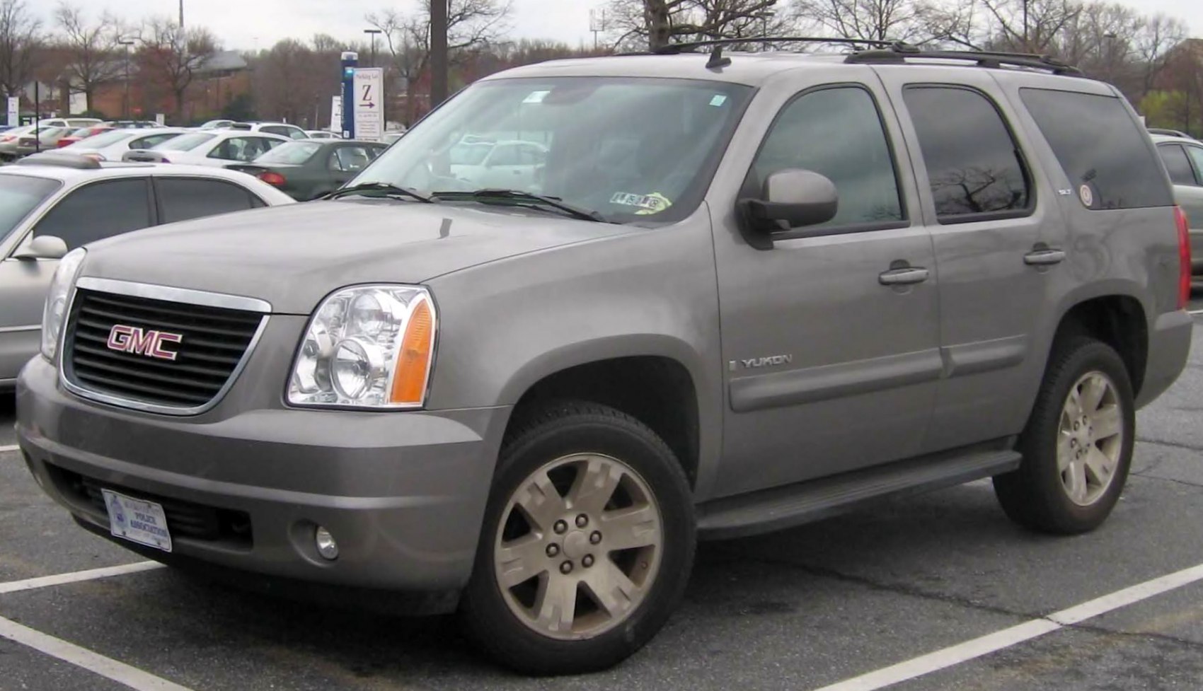 Gray SUV with front-side view and rugged design in a parking lot