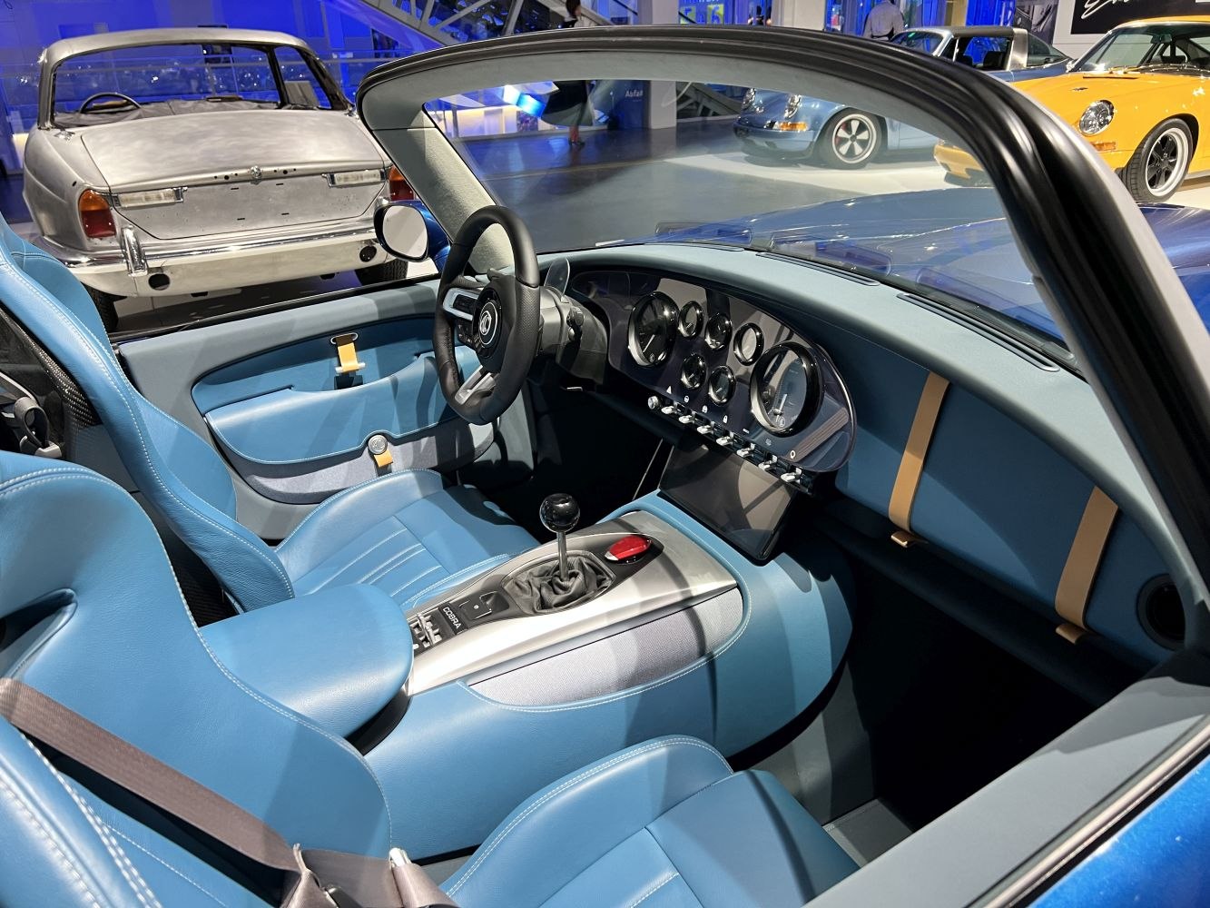 Blue leather interior with analog gauges and manual gear shift