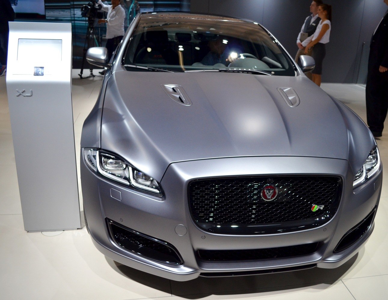 Close-up of sleek front grille and sharp LED headlights on luxury sedan