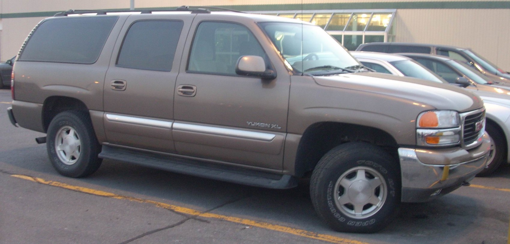Side profile with tinted windows, running boards, and alloy wheels
