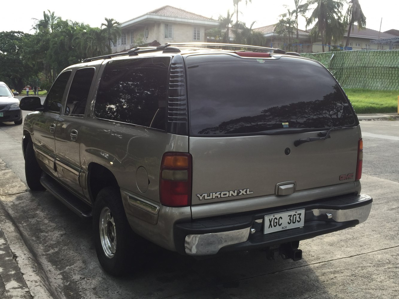 Rear view of a full-size SUV with tinted windows and roof rails