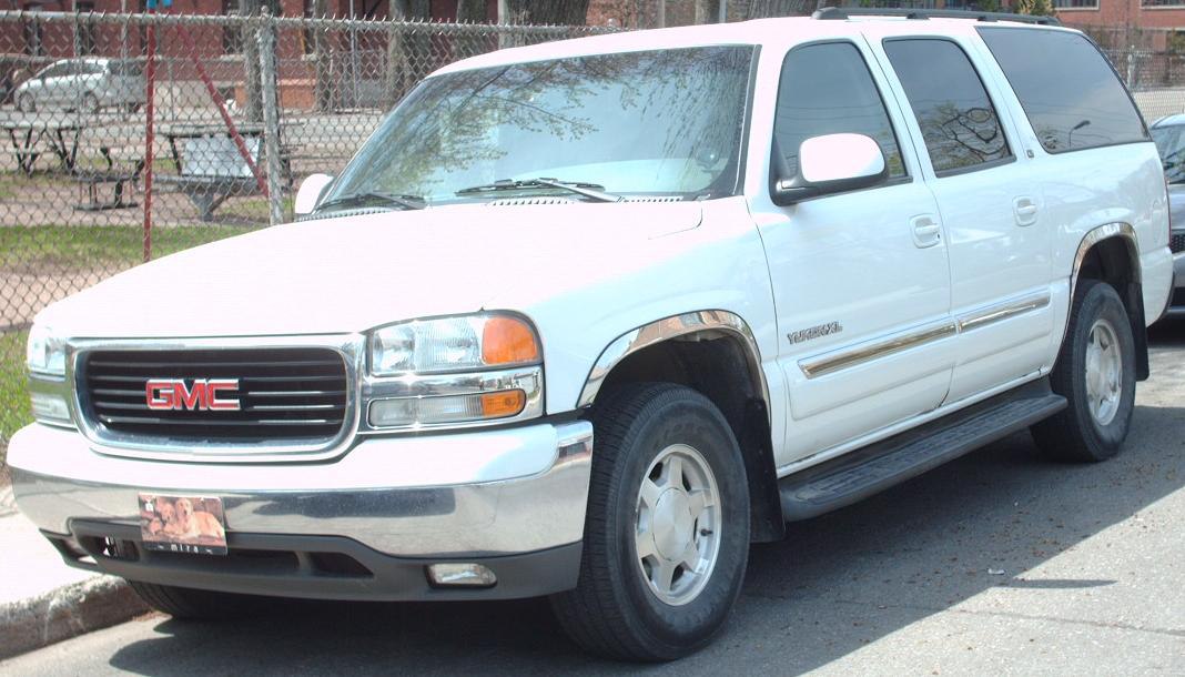Front and side profile of a large full-size SUV with prominent grille and SUV wheels