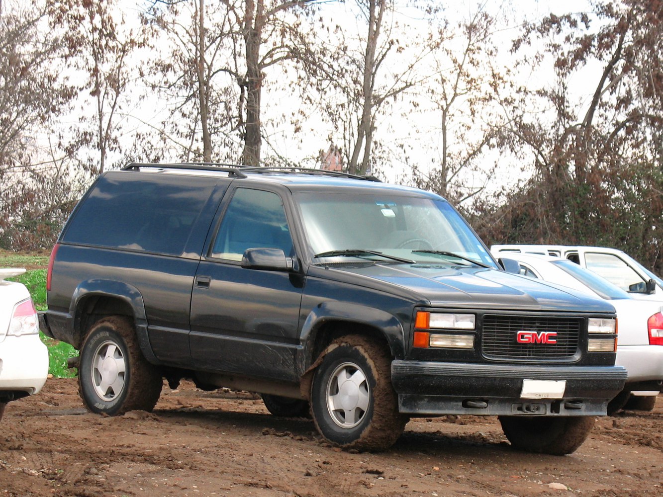 Black 1990s 3-door SUV with rugged tires and front grille.