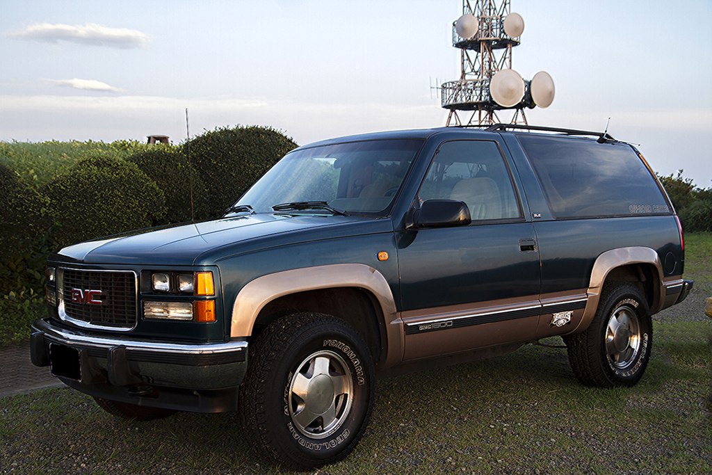 Boxy 3-door SUV with squared grille and rugged tires
