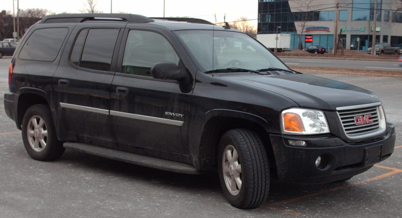 Black mid-2000s SUV with rugged body, roof rack, and classic front grille.