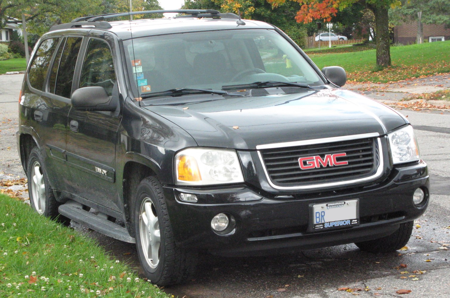 Front side of black SUV with GMC badge and roof rails