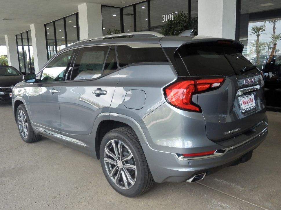 Rear and left side view of a metallic gray SUV with modern alloy wheels.