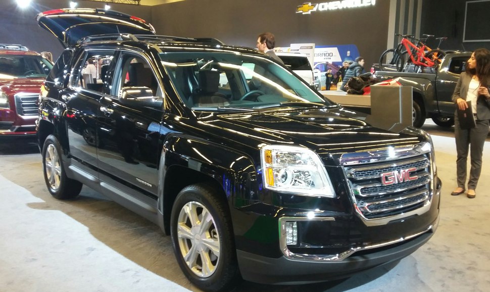Black SUV with open rear hatch and modern front grille