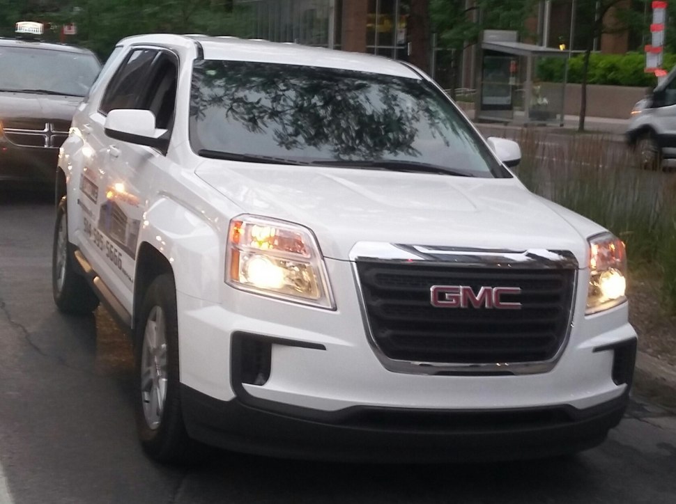 Front grille and headlights of a mid-size SUV with lights on
