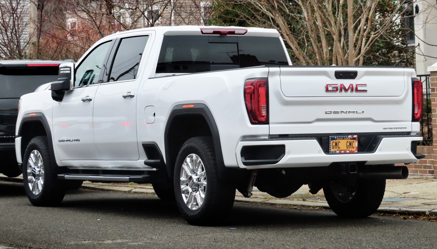 Rear view of a crew cab standard bed pickup with prominent tailgate and wheels