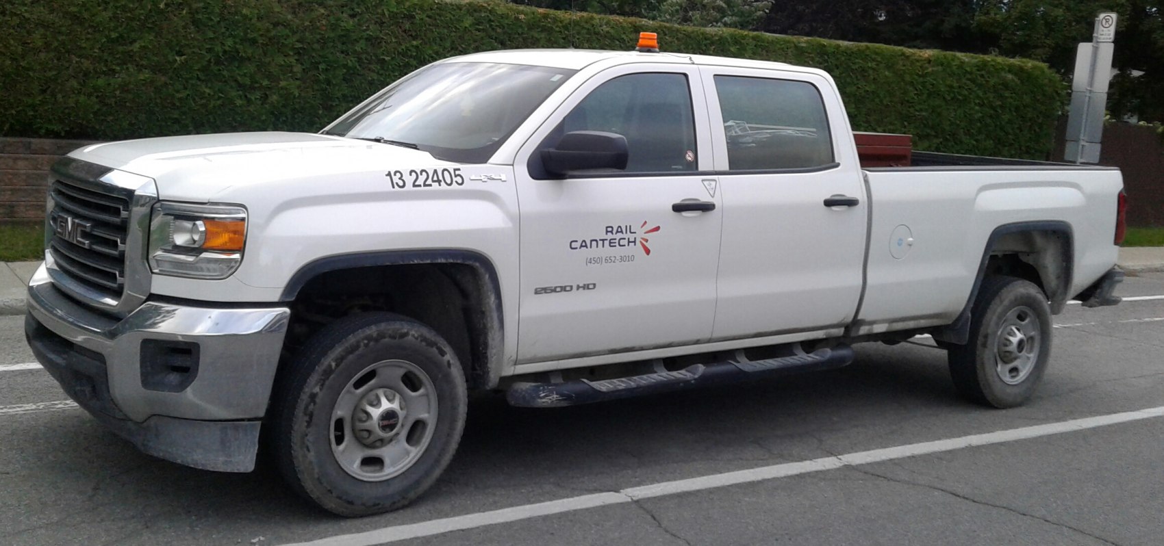 Heavy duty crew cab long box pickup with utility features and off-road tires