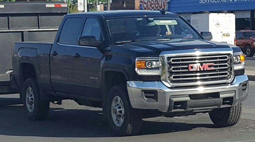 Front view of heavy-duty pickup featuring prominent grille and crew cab