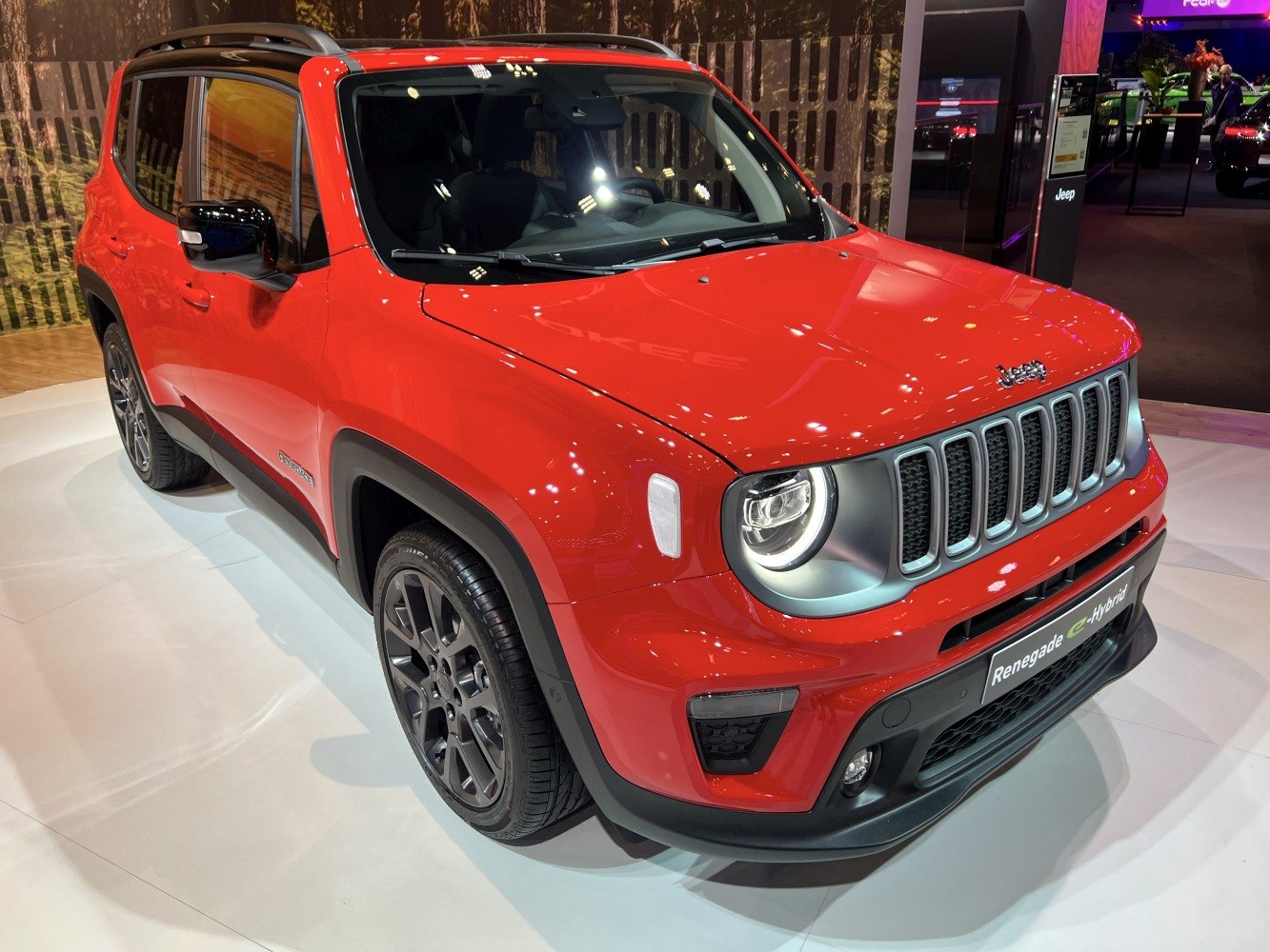 Red compact SUV with round LED headlights and front grille