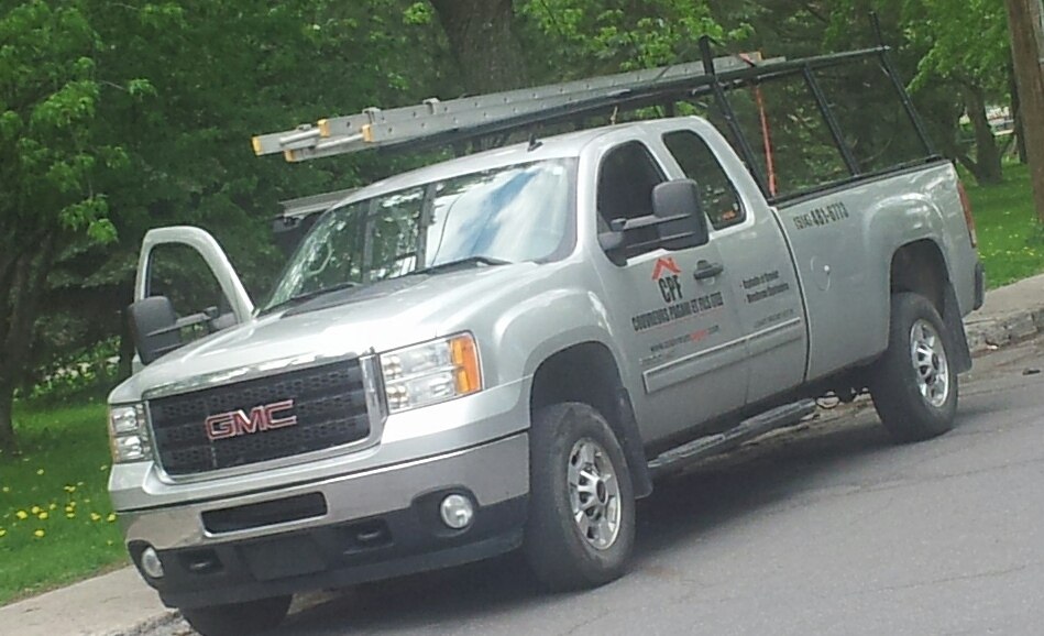 Silver pickup truck with extended cab and ladder rack