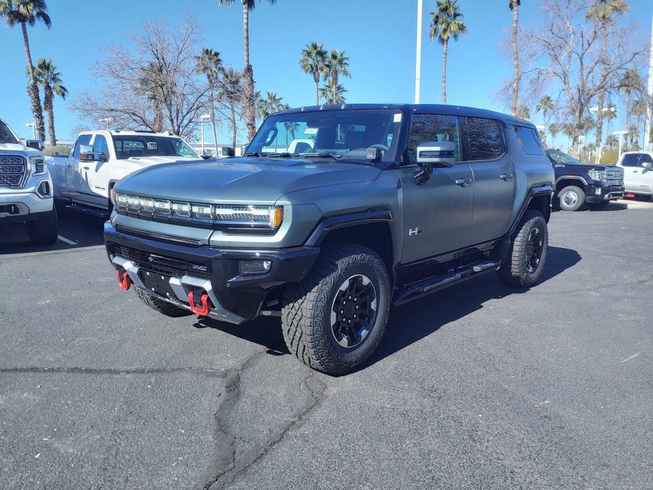 Robust front grille with LED headlights and off-road tires on an electric SUV