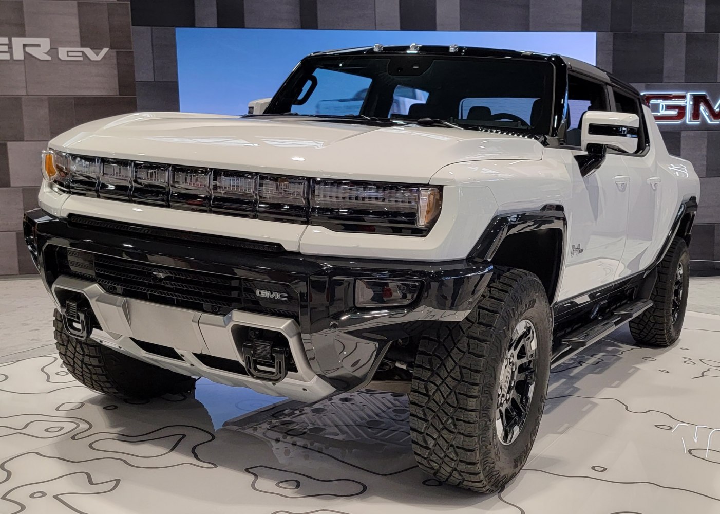 Front view of electric pickup with LED headlights and off-road tires