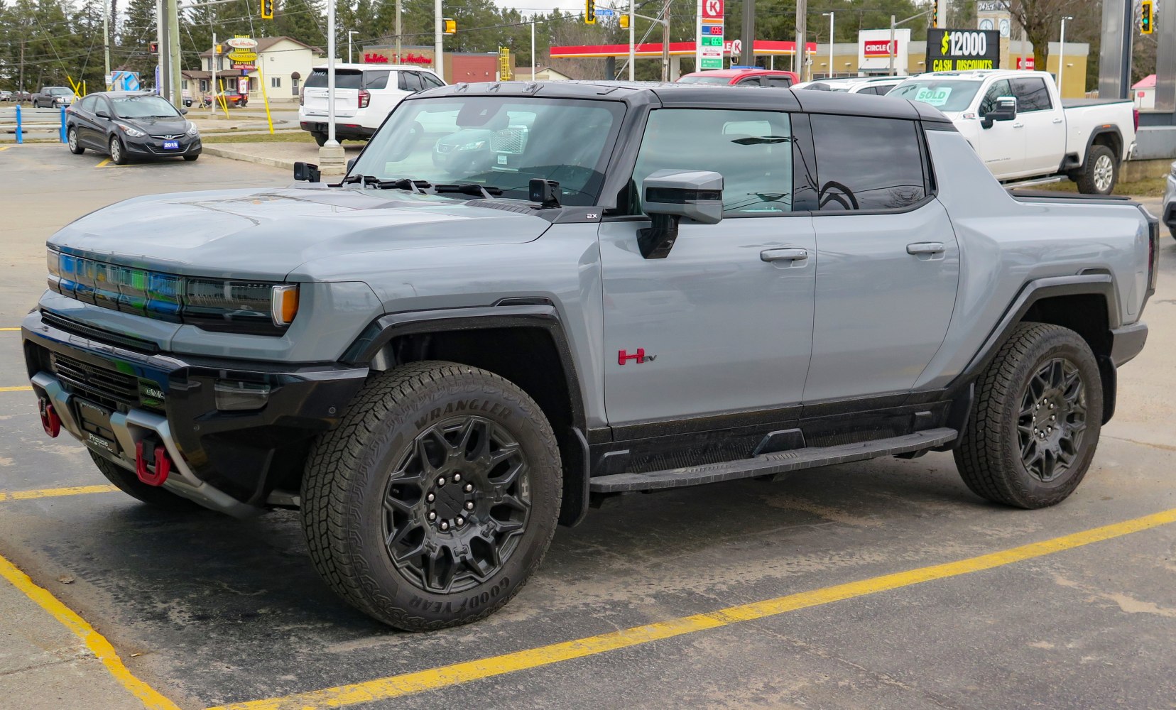 Electric pickup with aggressive front grille and rugged off-road wheels