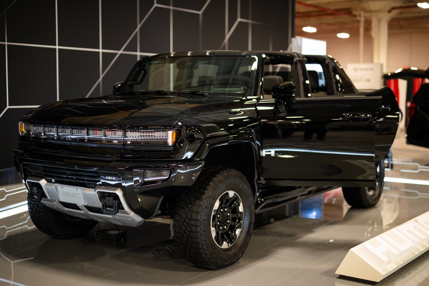 Front and side view of electric pickup with LED headlights and off-road tires