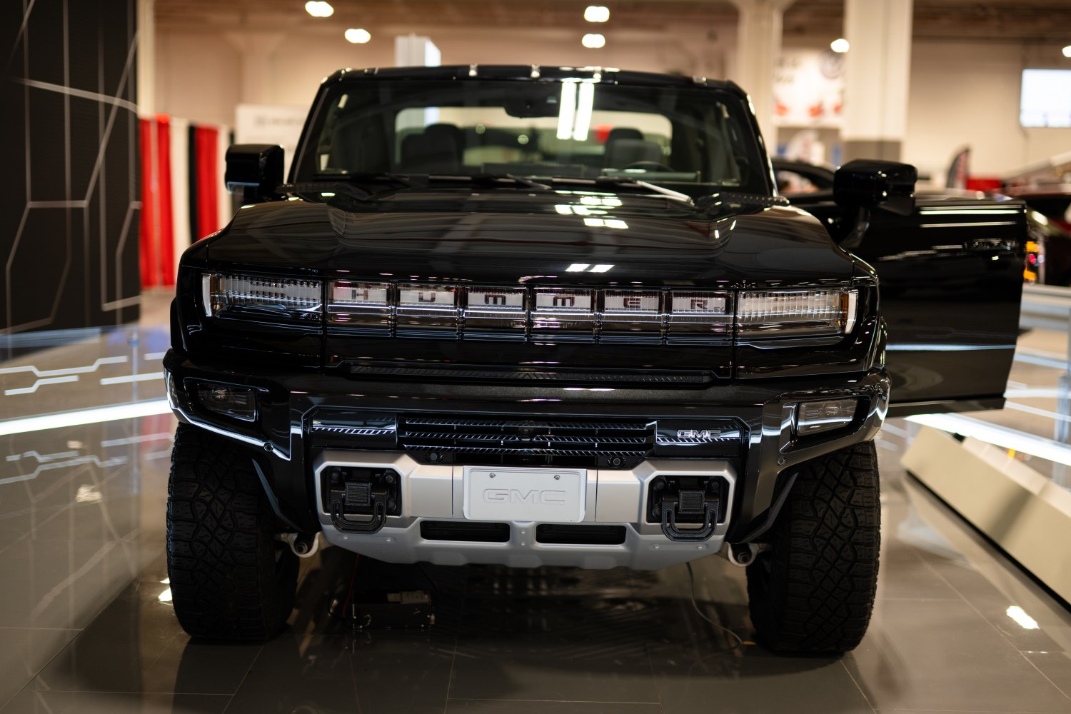 Close-up front view with distinctive signed grille and robust bumper